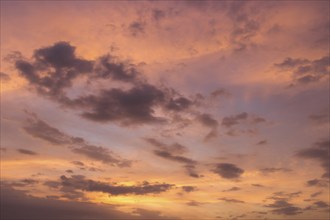 Purple sunset sky with clouds over the sea