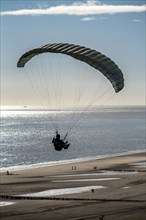 Paragliders along the dunes of Zoutelande, in Zeeland, South Holland, Netherlands