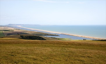 View west along Chesil beach tombolo from Abbotsbury to the Isle Portland, Dorset, England, UK