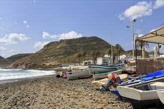 Fishing boats on a pebble beach, rocky coast, Cabo de Gata Natural Park, Las Negras, Almeria,