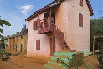 Traditional Malagasy two-story houses in street of rural village in the Ambositra District,