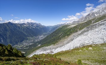 Mountain landscape with glacier Glacier des Bossons and view into the valley with the village of