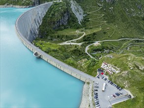 Dam of the Moiry lake, Lac de Moiry, turquoise glacial water, parking lot and restaurant at the