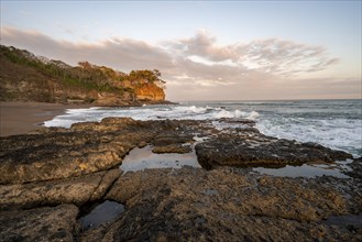 Sandy beach beach with rocks and sea at sunset, Playa Cocalito, coastal landscape, Pacific coast,