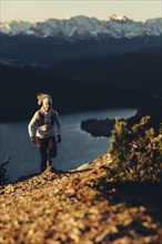 Trail running in autumn on the Jochberg on Lake Walchensee against the wonderful backdrop of the