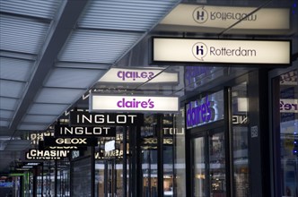 Illuminated shop signs in Lijnbaan shopping street Rotterdam, Netherlands