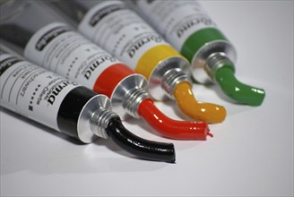 Four paint tubes, artist colours, green, yellow, red, black