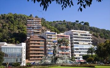 Water fountain by modern apartment buildings in the city of Malaga, Spain, Europe