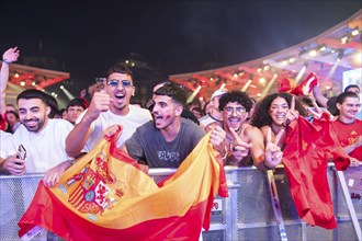 Spanish fans celebrate after scoring the 2:1 goal at the Adidas fan zone at the Bundestag during