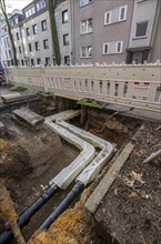 Construction site of a district heating house connection, pipes, insulated, are laid from a central