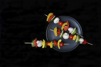 Colourful vegetable skewers on a plate, barbecue skewers