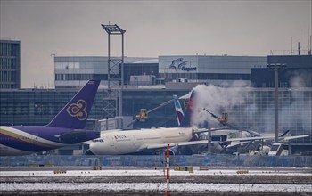 Winter at Frankfurt Main Airport, FRA, Delta aircraft being de-iced at the terminal, Hesse,