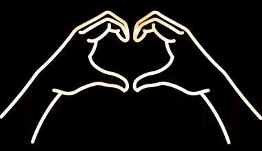 Electric neon lights of hands forming heart shape, Marlborough, Wiltshire, England, UK