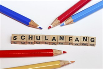 Symbolic image for the start of the new school year with letter cubes and pens