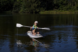 Little boy, 4 years old, paddling on surfboard, surfboard, lake, Schwaltenweiher, honey village