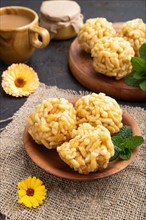 Traditional Tatar candy chak-chak made of dough and honey with cup of coffee on a black concrete