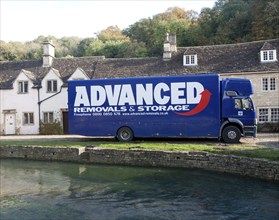 Removal van in Castle Combe, Wiltshire, England, UK claimed to be England's prettiest village