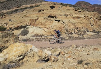 Person cycling in Cabo de Gata national park, Monsul, near San José, Almeria, Spain, Europe