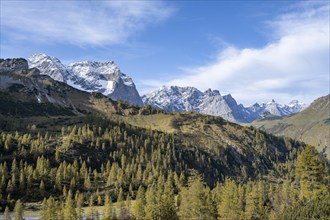 Mountain panorama with steep rocky peaks, yellow-coloured larches in autumn, view of Laliderspitze,