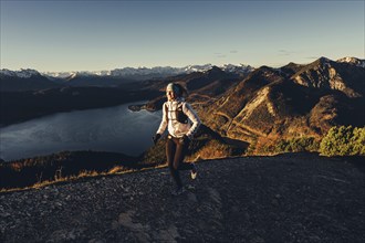 Trail running in autumn on the Jochberg on Lake Walchensee against the wonderful backdrop of the