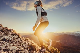 Trail running in autumn on the Jochberg on Lake Walchensee against the wonderful backdrop of the