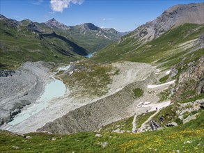 Hiking trail up to mountain hut Cabane de Moiry, glacial moraine, lake Lac de Moiry in the back,