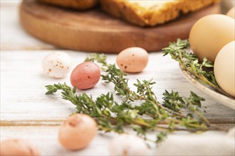 Homemade easter pie with raisins and eggs on plate on a white wooden background and linen textile.