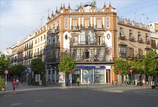 Historic buildings in Plaza del Altozano, Triana district, Seville, Spain, glass-fronted balconies