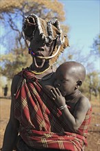 South Ethiopia, in Maco National Park, Mursi tribe, Mursi woman with baby, painted skin and