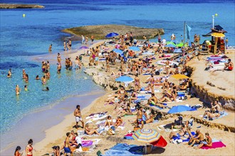 Bathers and sunbathers on the beach of Cala Comte bay, Ibiza, Balearic Islands, Mediterranean Sea,