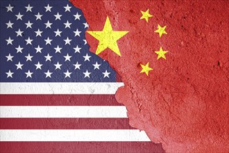 The US and Chinese flags on a cracked stone background