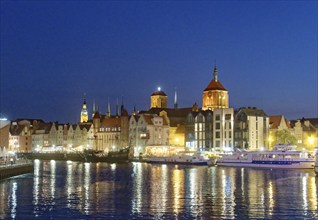 The harbour district on the Motlawa river, Motlawa, in the city centre of Gdansk, illuminated in