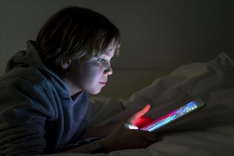 A boy plays computer games on a tablet PC