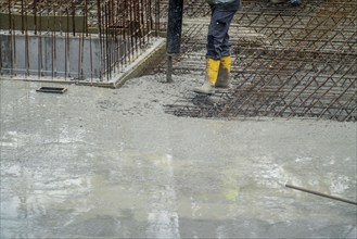 Construction site, concreting, the floor slab of a building is concreted, the concrete is pumped