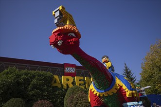 Dinosaurs in front of LEGO Arena, LEGOLAND theme park, Germany, Logo, Günzburg, Bavaria, Germany,