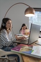 Homeschooling, during the lockdown in January 2021, children learning at home for school, a girl in