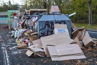 Overfilled waste paper containers, despite the overcrowding, people have put their waste paper next