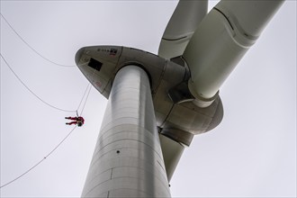 Height rescuers from the Oberhausen fire brigade practise abseiling from a wind turbine from a