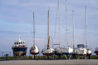 Boats, sailing boats laid up, wintering in the harbour of Norddeich, Lower Saxony, Germany, Europe