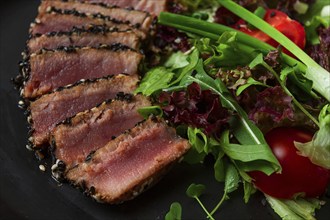 Vegetable salad, with fried tuna, in sesame seeds, healthy food, top view