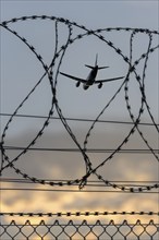 Symbolic image security, passenger aircraft taking off, security fence, Stuttgart Airport,