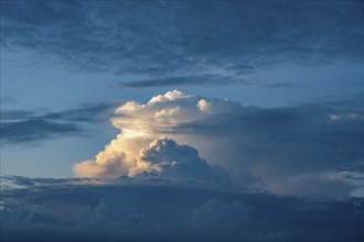 Towering cumulonimbus cloud, thundercloud, thunderstorm over the Swabian Alb illuminated by the