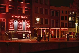 Night shot of the Oudezijds Achterburgwal in the red light district in Amsterdam, North Holland,