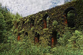 Historic moss-covered aqueduct Muro das Nove Janelas with 9 arched windows in the middle of the