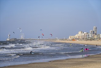 View over the beach of Scheveningen, the pier with Ferris wheel and the skyline of the town, which