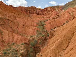 Eroded mountain landscape, canyon with red and orange rock formations, aerial view, Konorchek