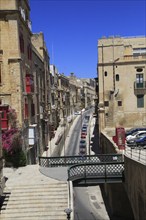 Historic buildings red telephone box iron bridge in city centre of Valletta, Malta, Europe