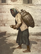 Cairo, drinking water carrier, Egypt, digitally restored reproduction from a 19th century original,