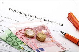 A rental agreement with euro banknotes and coins, studio