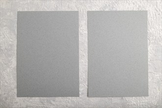 Gray paper business card, mockup on gray concrete background. Blank, flat lay, top view, still